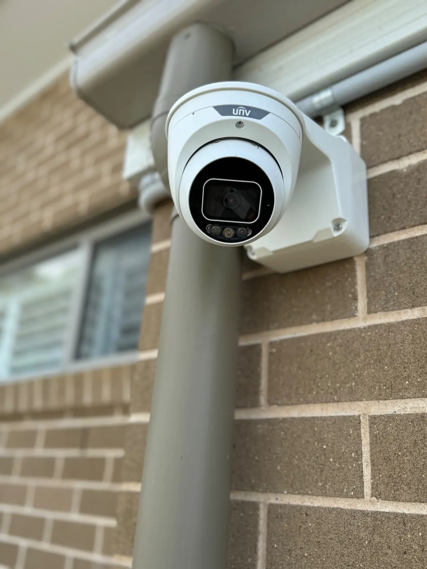 Outdoor CCTV camera installed on a brick wall